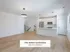 Bright and modern kitchen-living space in The Select Collection at Annex West Townhomes with sleek white cabinetry and stylish pendant lighting.