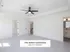 Bright and spacious bedroom in The Select Collection, featuring modern ceiling fan, pristine white walls, and plush carpeting with an adjacent sleek bathroom, perfect for luxurious living.
