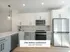 Elegant kitchen in The Select Collection at Annex West Townhomes showcasing modern appliances, sleek cabinetry, and a stylish open design.