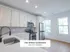 Bright modern kitchen in The Select Collection Annex West Townhomes featuring sleek cabinetry, stainless steel appliances, and elegant countertops.