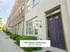 Charming row of modern townhomes with lush green landscaping and elegant brickwork, part of The Select Collection at Annex West.