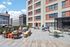 Vibrant urban rooftop patio featuring stylish seating, foosball table, and stunning city views.