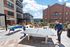 Vibrant outdoor recreation area with a ping pong and foosball table, perfect for social gatherings and leisure in a modern apartment complex.