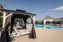 Luxurious outdoor pool area featuring elegant cabanas and inviting lounge chairs, perfect for relaxation and entertaining.
