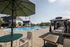 Luxurious outdoor swimming pool area with elegant cabanas and comfortable lounge chairs, offering a perfect spot for relaxation and leisure.