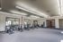 Sleek and modern gym featuring stationary bikes, mirrored walls, and ample natural light, perfect for invigorating workouts.