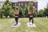 Two women practicing yoga outdoors on a sunny day in a lush green backyard, showcasing a vibrant and healthy lifestyle.