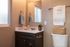 bathroom with dark modern cabinetry