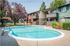 2-Bedroom Apartments in Concord, CA - Diablo View & Villa Diablo - Swimming Pool with Lounge Tanning Chairs, Table and Chairs, and Orange Umbrella