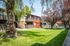 Concord, CA Apartments - Diablo View and Villa Diablo - Grassy Lawn and Property Exteriorwith Staircases, Red Walls, Tan Balconies, and Large Trees