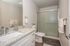 Concord, CA Apartments - Diablo View & Villa Diablo - Updated Bathroom With Large Mirror Behind Sink, Standing Shower, Wood-Style Flooring, And Counter With A Modern Faucet And Granite Countertops