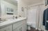 Concord, CA, Apartments - Diablo View & Villa Diablo - Bathroom with Granite Countertops, White Cabinets, Large Mirror, Vinyl Flooring, and Shower and Bathtub Combo