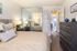 Concord, CA Apartments for Rent - Diablo View and Villa Diablo - Furnished Bedroom with a Bed, Rug over Wood-Style Flooring, Bench Seat, Wooden Nightstands, and a Window