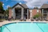 Community pool with sun chairs in front of apartments