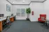 Business center with desks, chairs, and plenty of natural light
