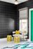 1810 The Social, interior, seating area, black wall, window, white floor, area rug with white, blue, green coloring, green door, white couch, yellow pillows and foot stools