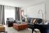 1810 The Social, interior, living room, black, tan, blue and red decor, sofas, arm chairs, black and white drapes, large window