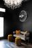 1810 The Social, interior, seating area, dark floor, black walls, chandelier, gray couch, yellow pillows and foot stools, sign 'The Jim'