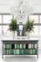 1810 The Social, interior, white wall, windows, white floor, chandelier, potted plants, coffee maker, table with books on bottom shelves, green tones
