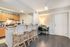 1810 The Social, interior, kitchen, dining room, table for two, breakfast bar seating for four, checked floor, carpet floor, white appliances, refrigerator, microwave, stove/oven, wood cabinets,