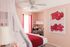 1810 The Social, interior, bedroom, white, red and pink decor, bed, wall art, desk and chair, bed curtain, laimp