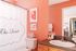 1810 The Social, interior, bathroom, pink and white bathroom, 'The Social' logo on shower curtain, wood cabinet, large mirror
