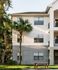 1800 The Ivy, exterior, white and gray buildings, three levels, balconies, palm trees, grass, picnic table