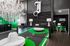 1800 The Ivy, interior, seating area, dark walls and floors, green accents, white circular sofa, mirrors, chandelier, windows, green doors, member service sign in next room, green chairs