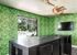 1800 The Ivy, interior, black table and chairs, green leafy wall paper, tv, window to pool area