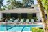 1800 The Ivy, exterior, sparkling blue swimming pool, lounge chairs, shaded pavilion seating, palm trees, trees