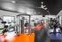 1800 The Ivy, interior, fitness center, black, orange, and purple flooring, ceiling fans, large windows, weight machines, elliptical, treadmills