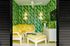 1800 The Ivy, interior, tv room, yellow and white sofa, ottoman, dresser, tv, green foliage wall paper