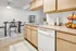 Kitchen with wooden cabinets and adjacent dining space | Cedar Breaks | Apartments in Taylorsville, UT