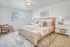 Primary bedroom with plush bedding and elegant finishes | Cedar Breaks | Apartments in Taylorsville, UT