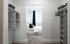 Inviting bedroom view through a walk-in closet featuring organized shelving and elegant design.| Point of View | Apartments in Draper, Utah