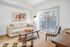 Elegant living room with a beige sofa, stylish checkered chairs, and large sliding glass doors for ample natural light.| Point of View | Apartments in Draper, Utah
