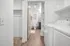 Contemporary apartment utility area with washer, dryer, and adjacent stylish bathroom.| Point of View | Apartments in Draper, Utah