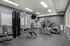 Modern apartment gym with state-of-the-art fitness equipment, including treadmills and strength machines, in a sleek and inviting environment.