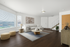 Elegant living room with natural light, featuring a modern sectional sofa, chic wooden furniture, and a cozy area rug, exuding comfort and style.
