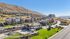 Stunning apartment complex nestled against picturesque hills, featuring modern buildings, lush landscaping, and a spacious playground. | Triton Terrace | Apartments Draper, Utah