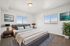 Elegant bedroom with panoramic views, stylish decor, and abundant natural light, featuring a cozy king-size bed and modern furnishings. | Triton Terrace | Apartments Draper, Utah