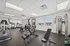 Modern apartment fitness center featuring state-of-the-art exercise equipment, bright lighting, and spacious layout. | Triton Terrace | Apartments Draper, Utah