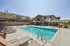 Modern apartment complex with a sparkling outdoor pool, sun loungers, and scenic mountain views, offering a luxurious living experience. | Triton Terrace | Apartments Draper, Utah