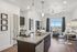 Contemporary apartment kitchen and dining area with sleek granite countertops, stylish furnishings, and stunning natural light from large window with city view. | Point of View | Apartments in Draper, Utah