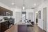 Modern kitchen with sleek dark cabinets, stainless steel appliances, and a stylish granite island with seating. | Point of View | Apartments in Draper, Utah