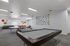 Spacious recreational room with pool table, ping pong setup, and vibrant wall decor, ideal for entertainment and relaxation.