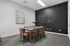 Inviting meeting room at Bengal Creek with a modern table, sleek chairs, and a welcoming chalkboard wall.