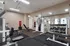 Modern fitness center featuring state-of-the-art gym equipment, sleek mirrors, and ample workout space for an invigorating exercise experience.