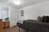 Cozy bedroom featuring a sleek design with modern furniture, stylish double closet doors, and plenty of natural light.