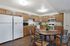 Inviting kitchen with sleek wooden cabinets, modern appliances, and a stylish dining area perfect for entertaining.